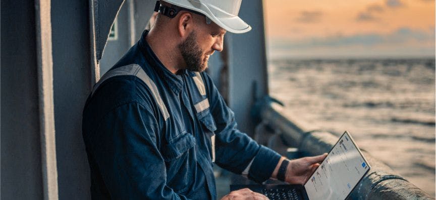 Seafarer searching for an offshore job on laptop